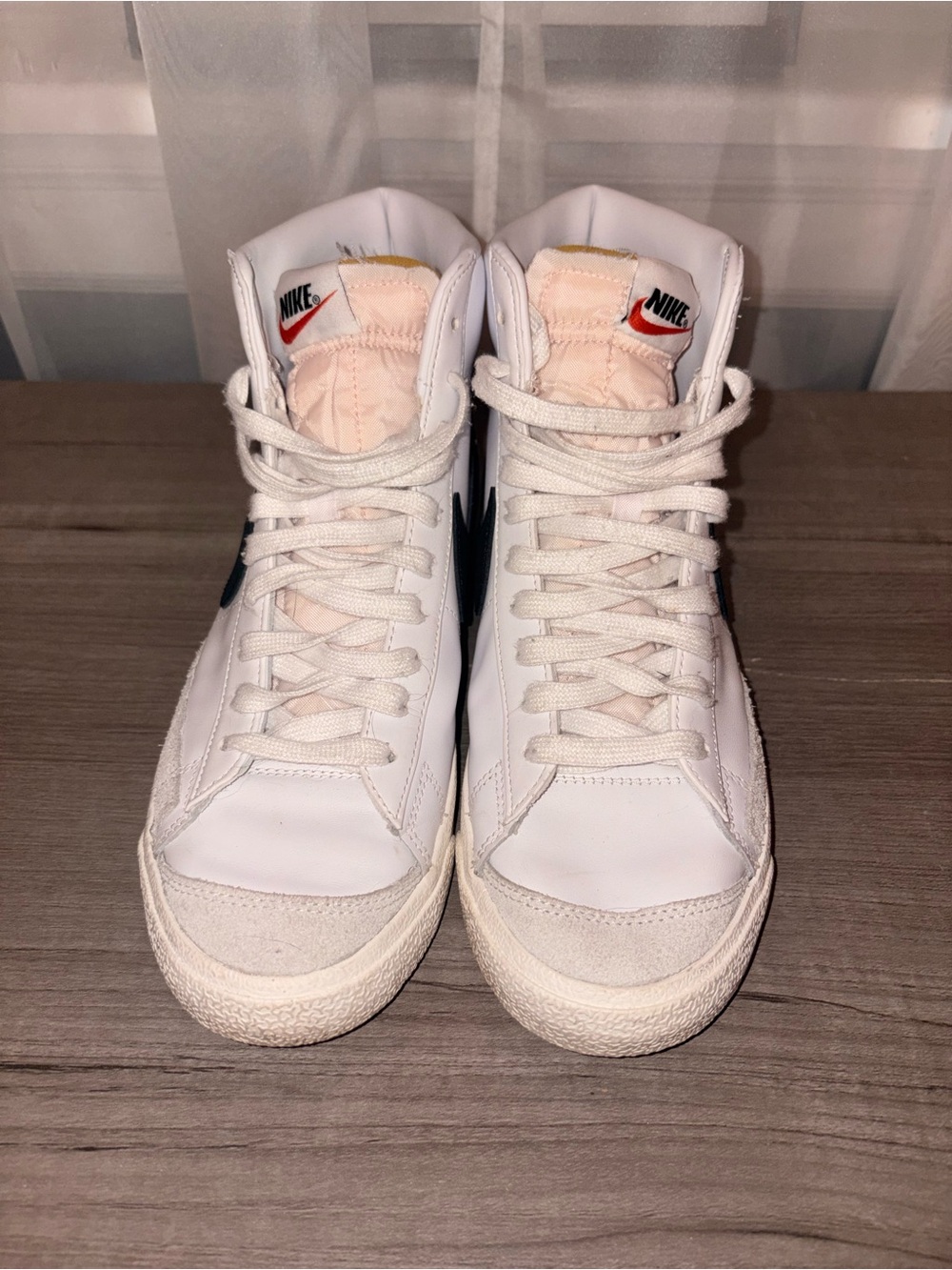 Nike White High-Top Sneakers with Black Swoosh and Red Tongue Accent